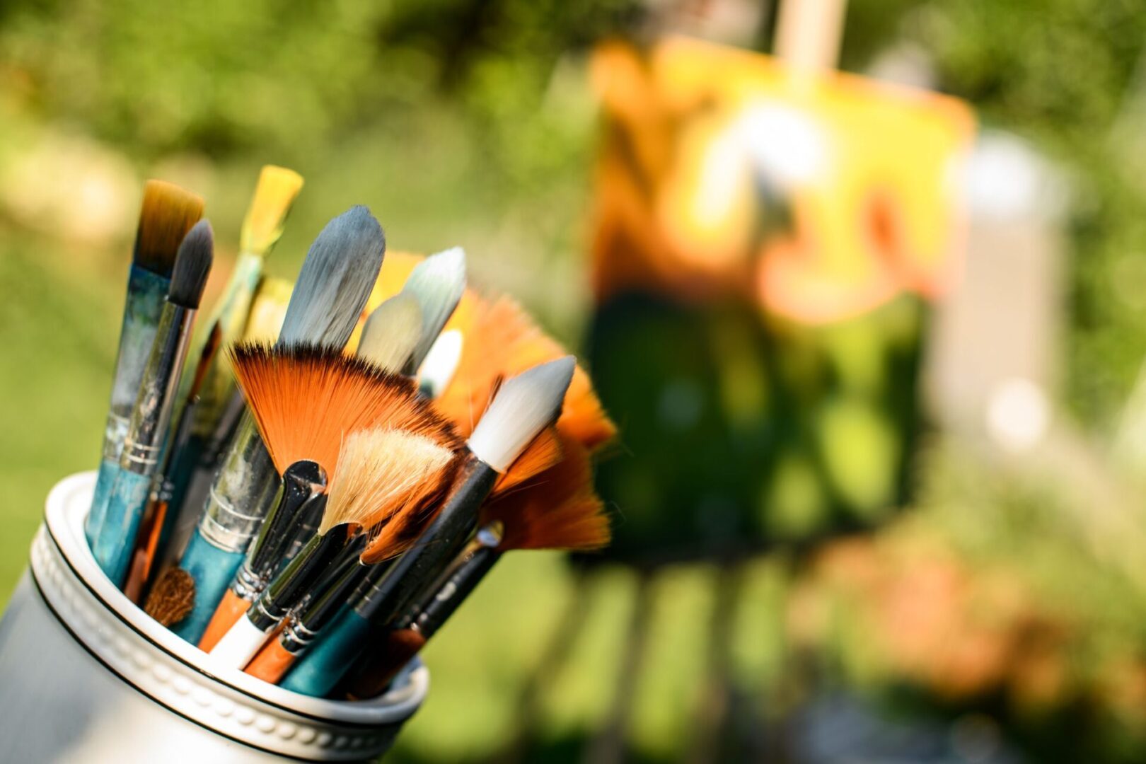 A close up of some paint brushes in a cup