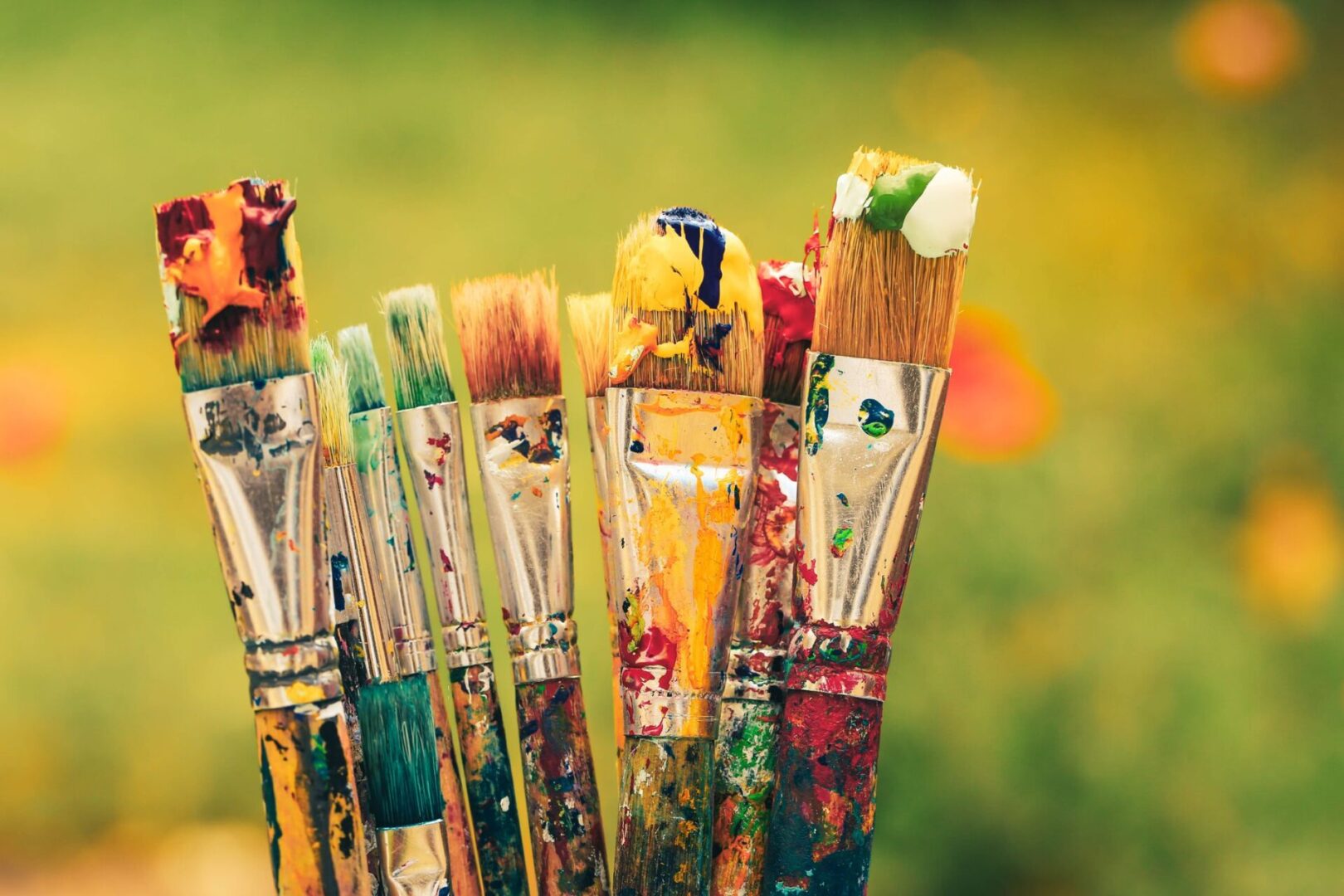 A close up of some paint brushes with different colors